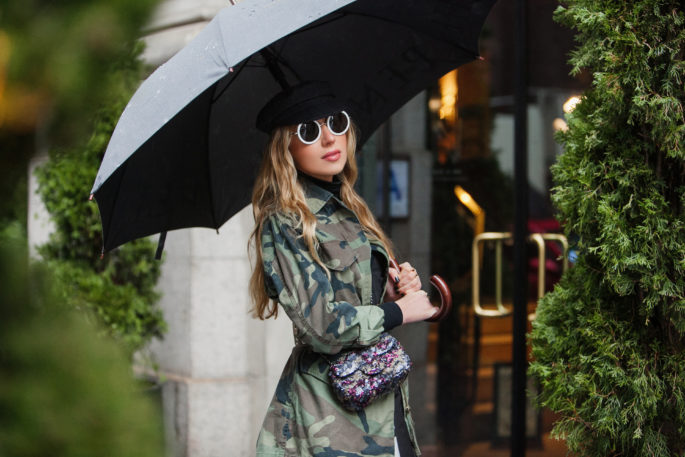 Rainy day fashion,topshop camo jacket,how to wear camo and sequins,nyfw 2017,NYFW street style,the row 8 sunglasses,NYC taxi,nyfw17,how to mix camouflage and floral print,prada flower print dress,NYFW17 street style,camo and sequins,chanel sequin bag,dior boots,topshop camouflage,topshop jacket,NYC view from the window,dior white boots,chanel camo sequin bag,marni belt,dior patent leather boots
